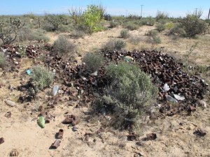 A huge pile of burnt tin cans sits and waits