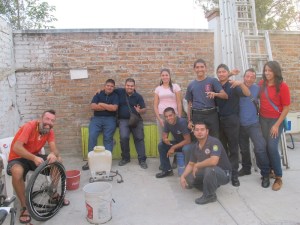 Bren checks for a puncture while the crew watches eagerly