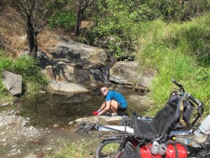 Finding a clear stream by the side of the road s a real treat. we stopped to wet our hats and tops for some air con riding