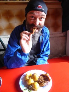 Bren takingbhis 1st taste of 'cuy' - guinnea pig. Much nicer than it sounds or looks