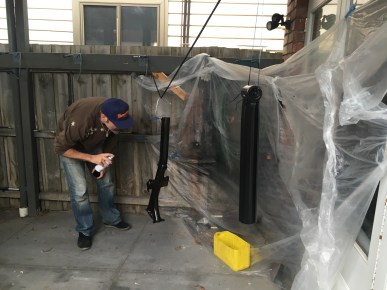 Bren in what looks like a 'kill room', spraying up Falkor in fashionable new black.